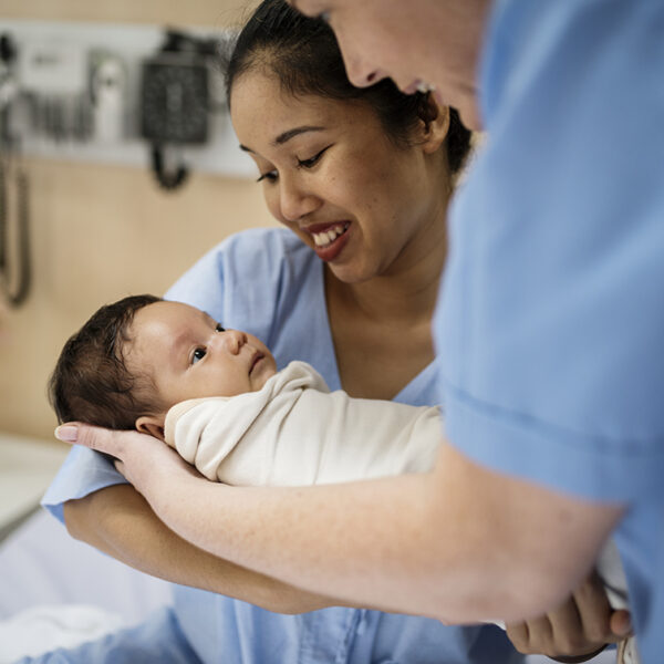 A nurse holding a newborn baby